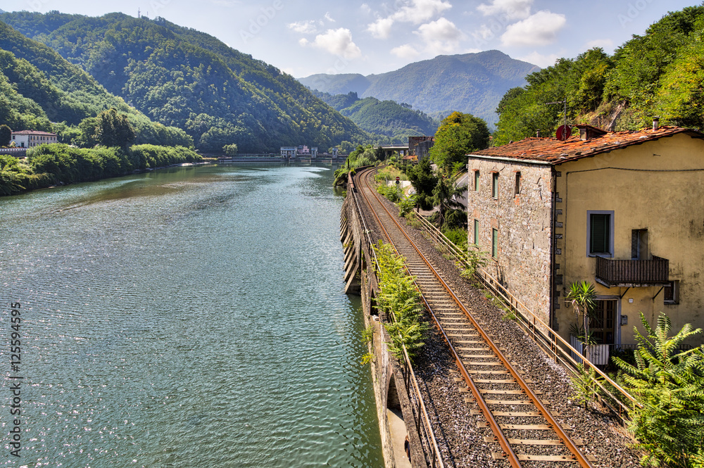 railroad along the river Serchio and Apuan Alps, Tuscany, Italy