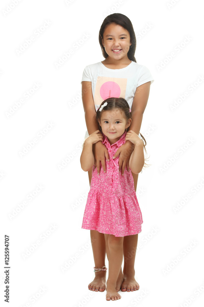 Sisters hugging isolated on a white background Sisters hugging isolated on a white background