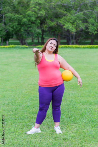 Beautiful fat woman playing yellow ball in the park. in the park © ijetdo
