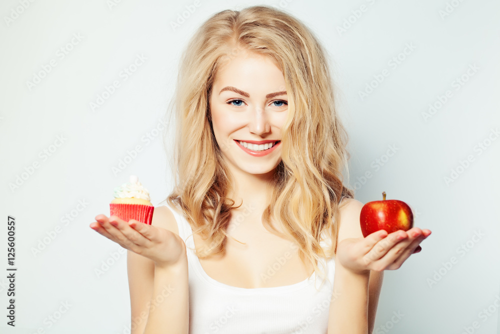 Smiling Woman with Healthy and Unhealthy Food. Difficult choice. Smiling Woman with Healthy and Unhealthy Food. Difficult choice.