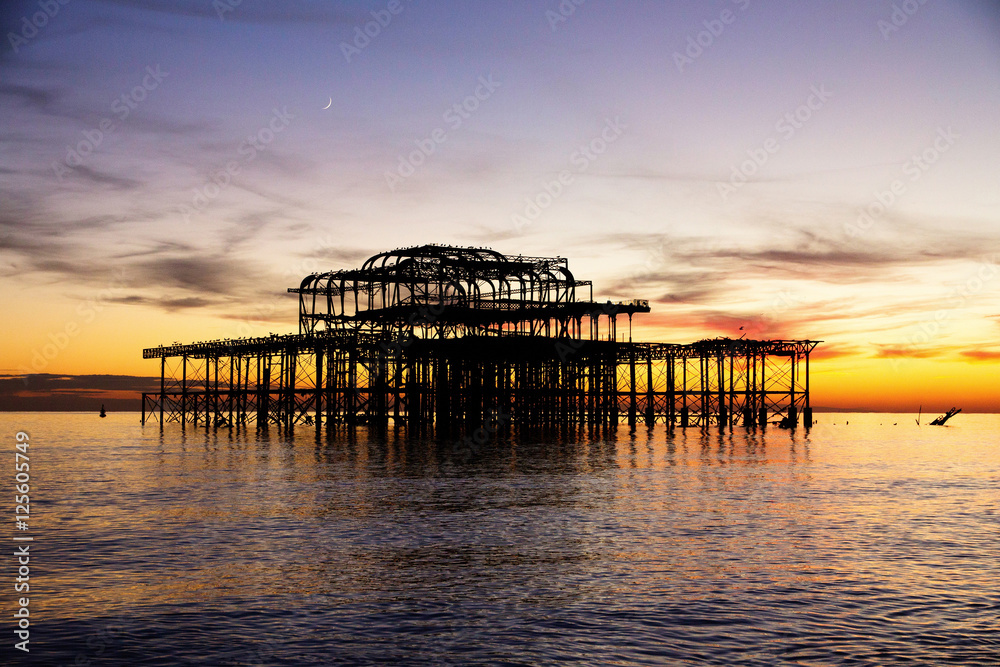 Remains of Brighton Pier left standing in sea, sunset, Brighton Remains of Brighton Pier left standing in sea, sunset, Brighton