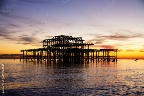 Φωτογραφία Remains of Brighton Pier left standing in sea, sunset, Brighton