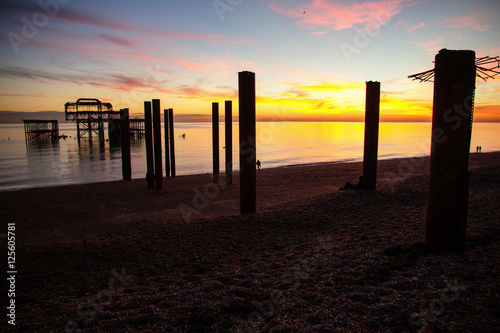 Remains of Brighton Pier left standing in sea at sunset, Brighton