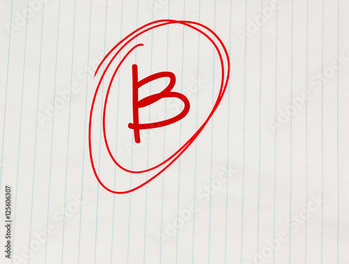 B grade written in red on notebook paper photo