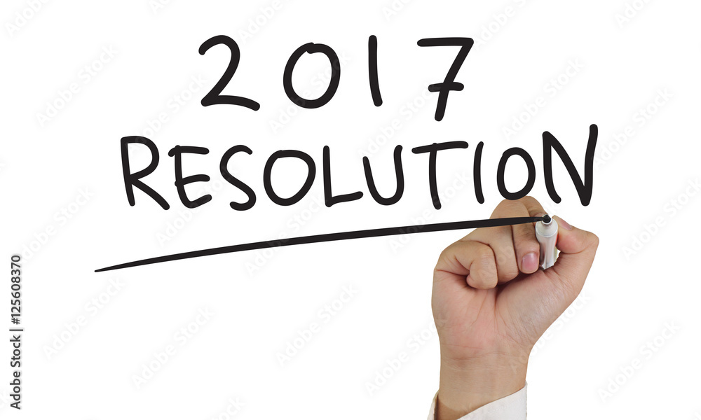 Photo image of businessman hand writing 2017 new years resolutions isolated on white Photo image of businessman hand writing 2017 new years resolutions isolated on white