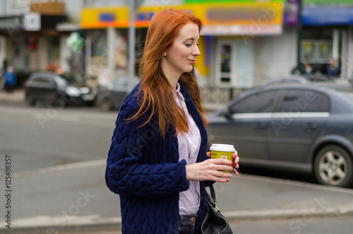 Young red woman with hot coffee