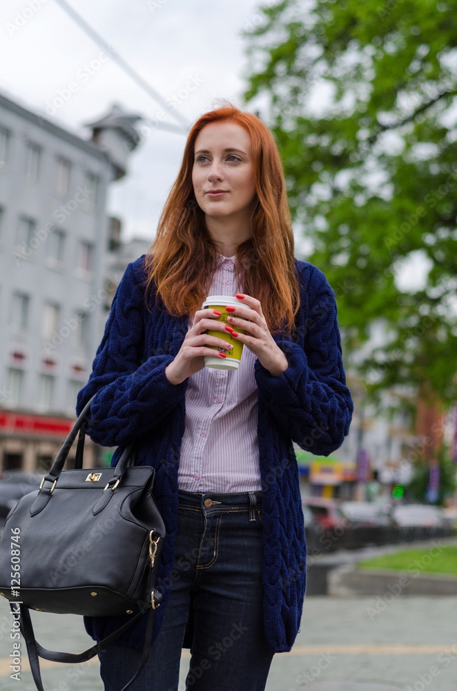 Fototapeta premium Young red woman with hot coffee