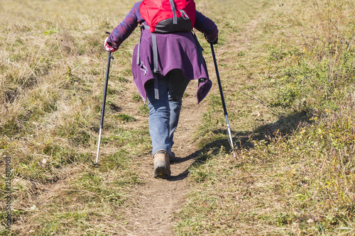 Older woman walking by hiking trail
