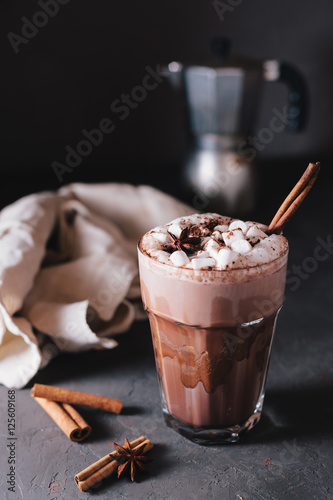 Cocoa or latte or hot chocolate with marshmallow and flavored with cinnamon. On a gray concrete background. Christmas present. Christmas concept. Christmas holiday.