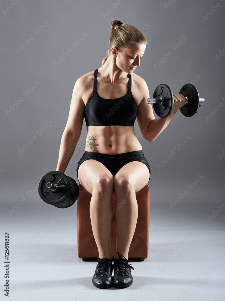 Girl doing biceps curl with dumbbells Girl doing biceps curl with dumbbells