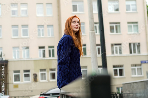 Young red woman walking in the city