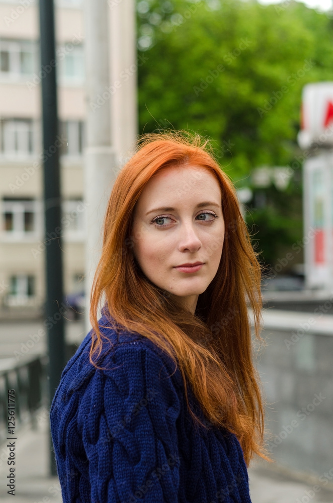 Young red woman walking in the city Young red woman walking in the city