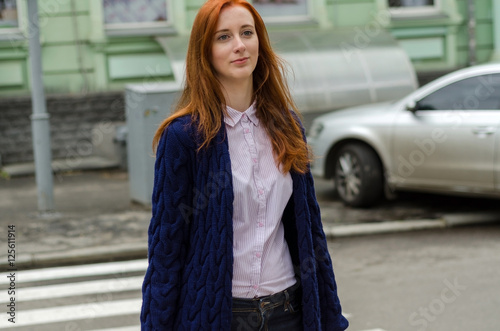 Young red woman walking in the city