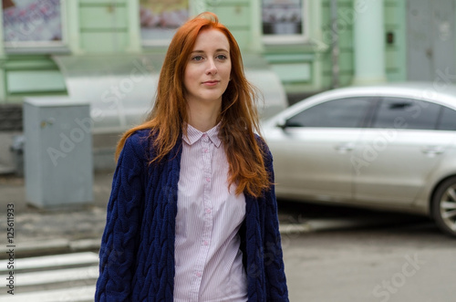 Young red woman walking in the city