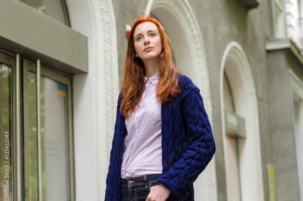 Fototapeta premium Young red woman walking in the city