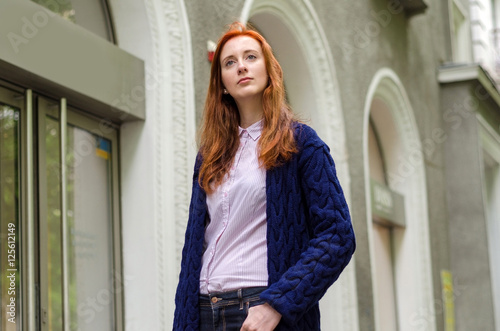 Young red woman walking in the city