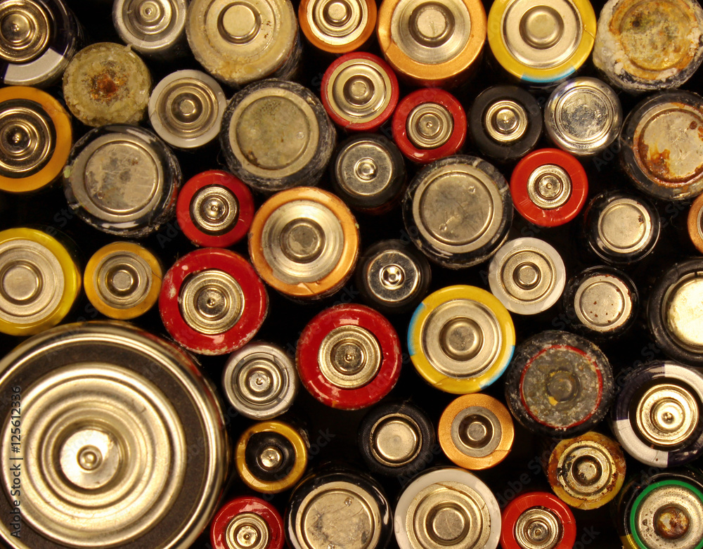 Old electric batteries on black background Old electric batteries on black background