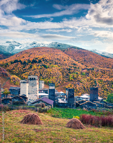 Colorful autumn scene in famous highest inhabited village in Eur photo