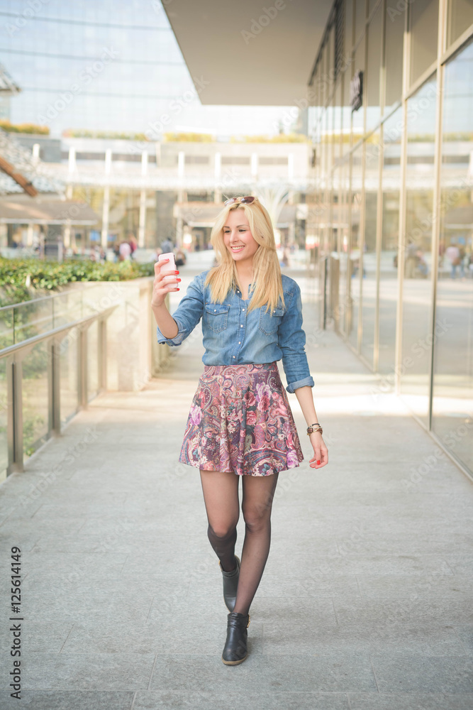 Young beautiful caucasian blonde girl in the city Young beautiful caucasian blonde girl in the city