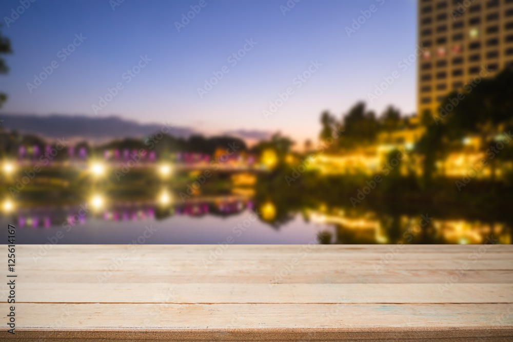 Empty of wood desk form and bokeh light of night city scape back