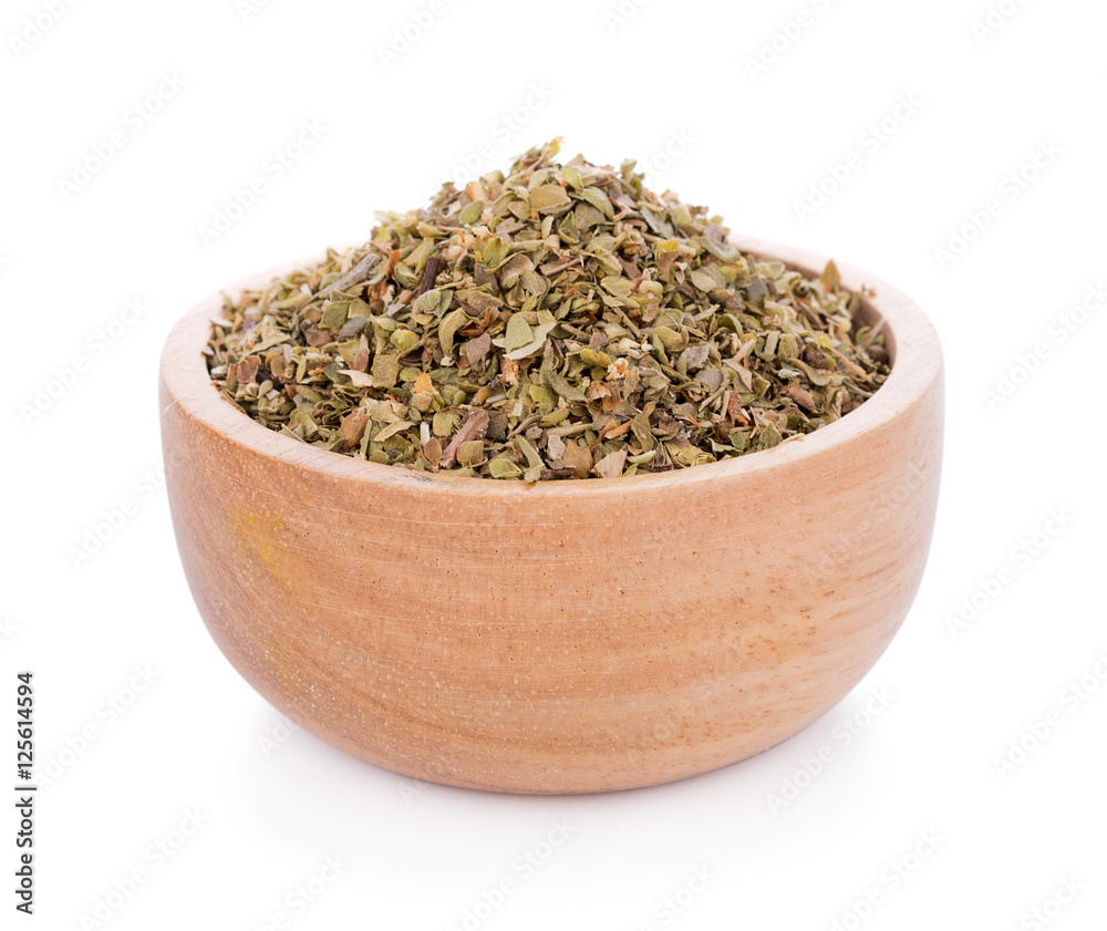 Dried Oregano on wooden bowl on white background Dried Oregano on wooden bowl on white background