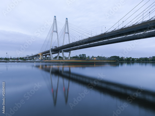 Bolshoy Obukhovsky Bridge (Cable stayed Bridge) at the summer morning light with the shadow of ship, Saint-Petersburg, Russia