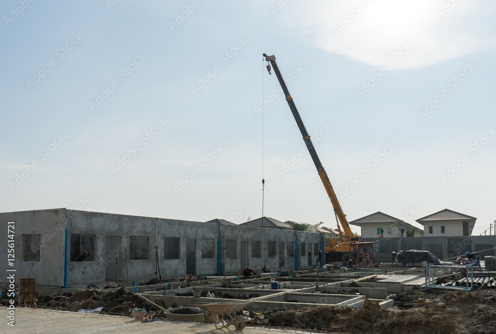 Construction site crane is used to placing precast concrete pane