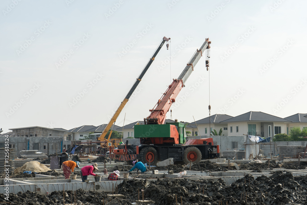 Construction site crane is used to placing precast concrete pane Construction site crane is used to placing precast concrete pane
