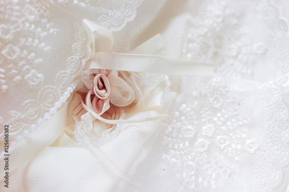 Fototapeta premium Cute background with laces and silk rose. Details of newborn baby girl's dress.
