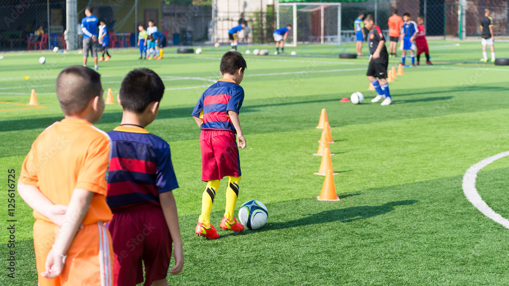 Naklejka premium Children Training in Soccer academy
