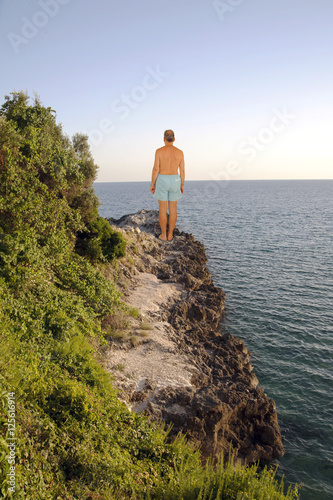A man alone on a cliff (horizontal)