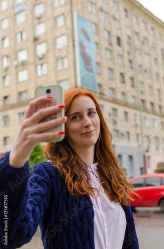 Young red woman making selfie 