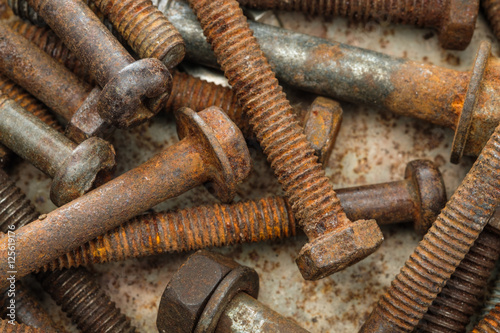 old rusty bolts dirty on rusty metal plate background