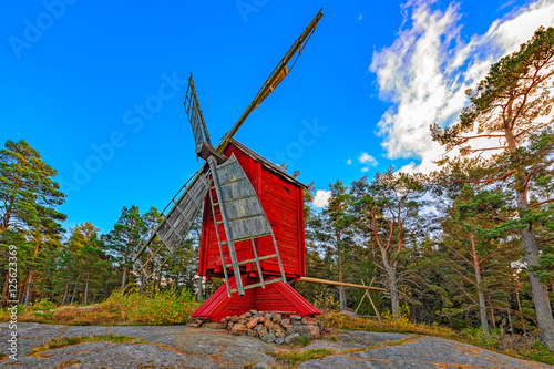 Red ochre colour wooden windmill photo