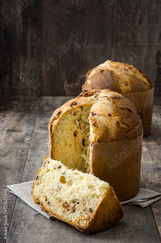 Christmas cake panettone on a rustic wooden background