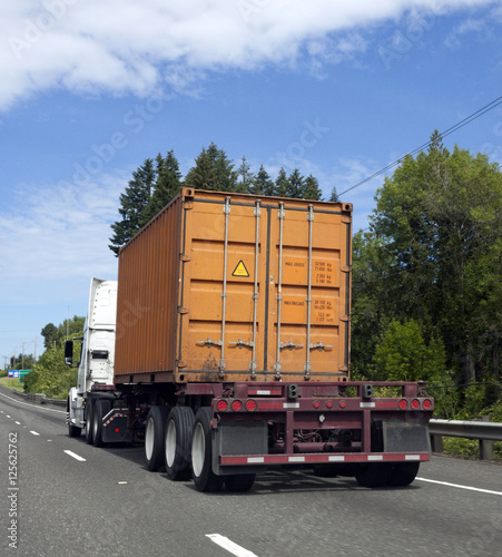 Orange Cargo Container on Semi Truck Flatbed