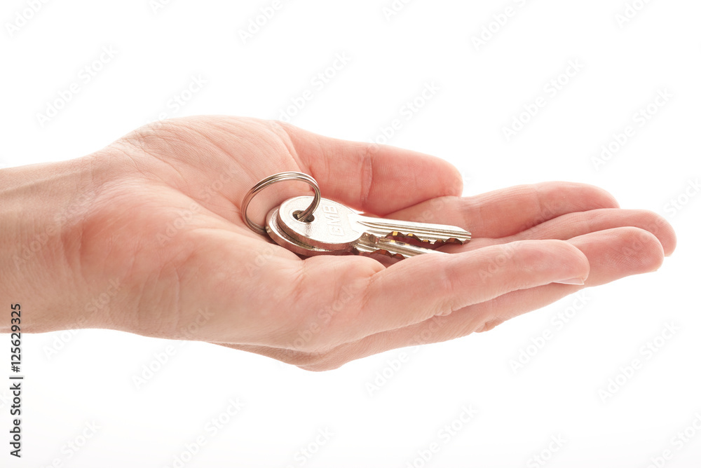 house key in hand on a white background