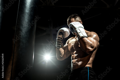 boxer in gym with punching bag