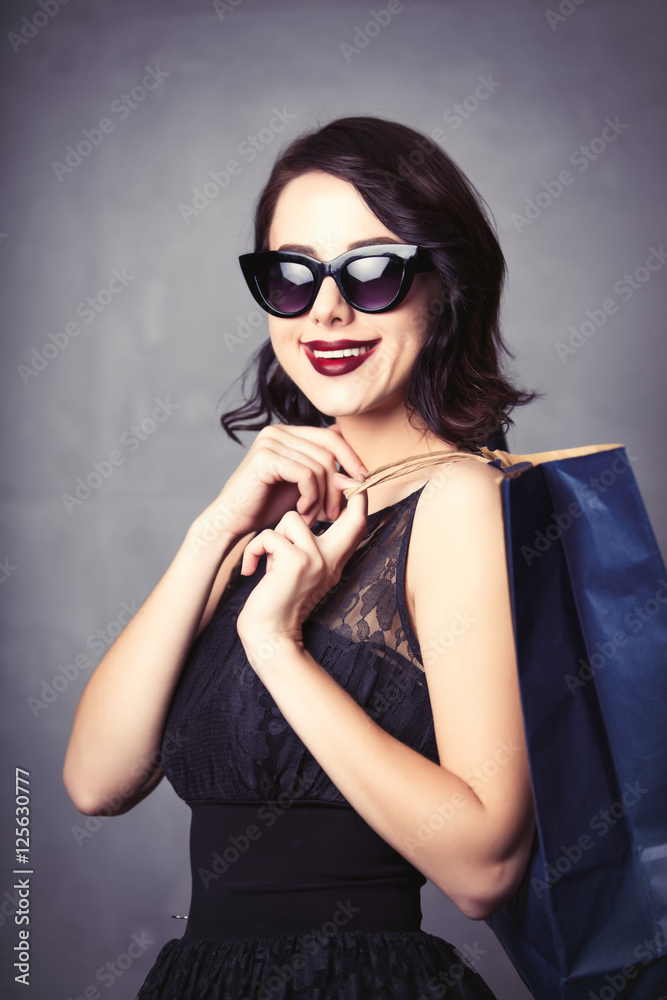 woman in black dress with shopping bag woman in black dress with shopping bag