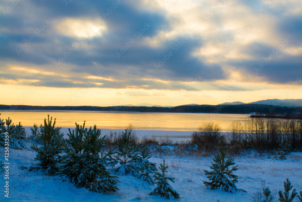 Frozen lake on the background of Ural mountains