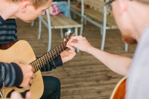 Learning to play the guitar. Music education and extra-curricular lessons.