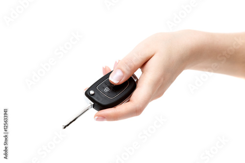 Female hand holds car keys.