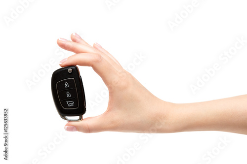 Female hand holds car keys.