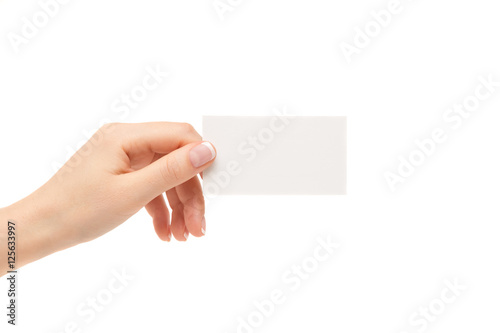 Female hand holds white card on a white background.