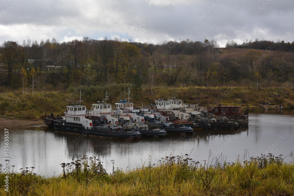 ships, barges in the river port, autumn industrial landscape