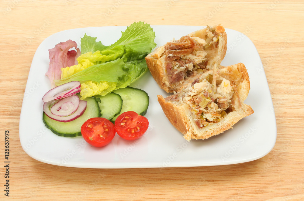 Pie with salad on a plate