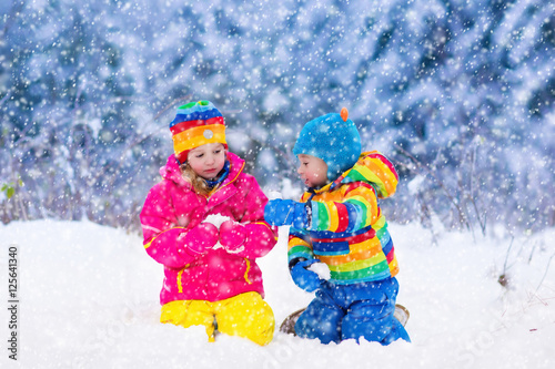 Children playing in snowy winter park