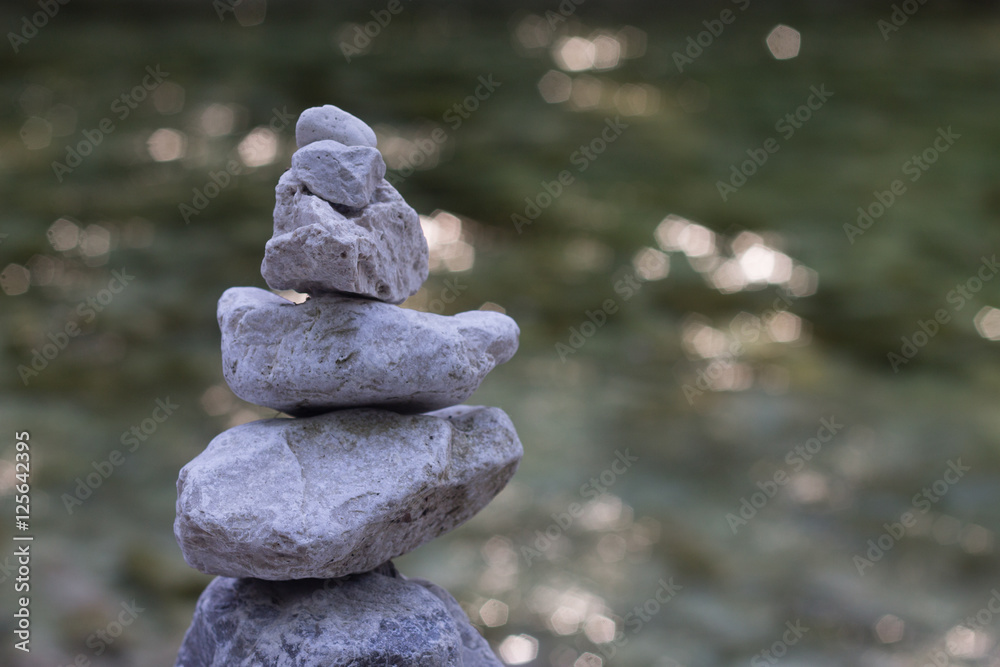 Stone pyramide with river on backbaround peace symbol Stone pyramide with river on backbaround peace symbol
