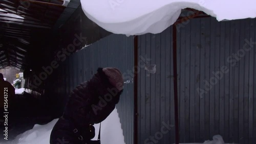 Big snowball falls on the girl's head photo