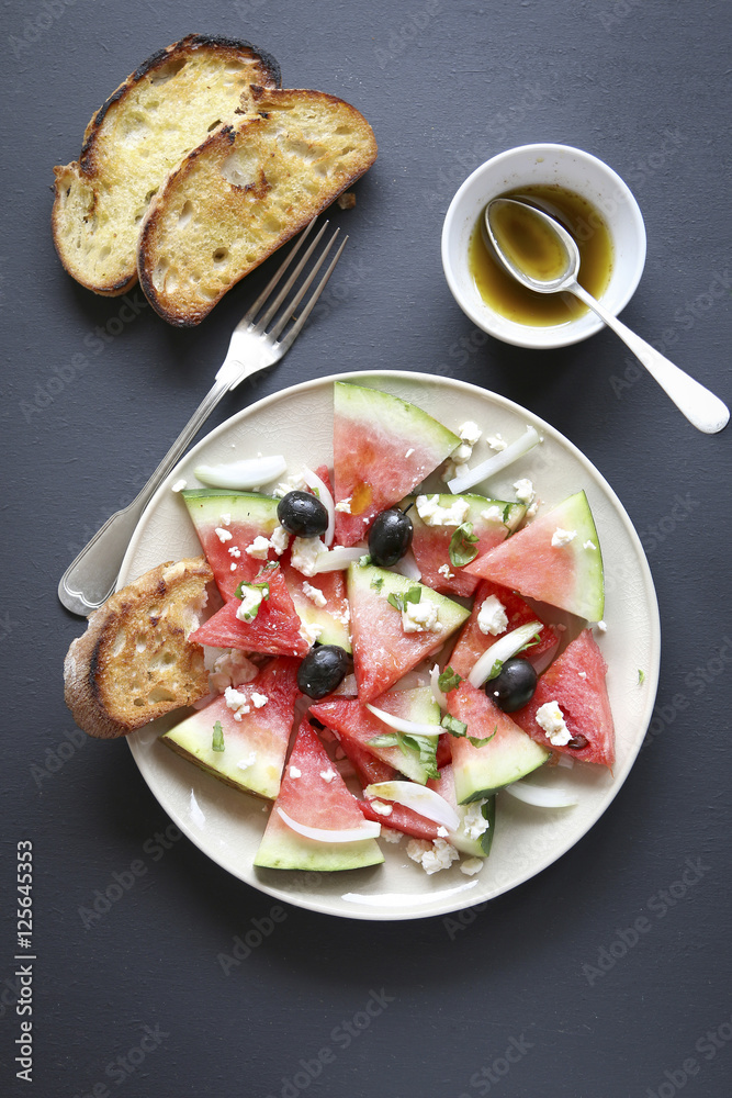 Watermelon salad with feta cheese,black olives,onion and basil Watermelon salad with feta cheese,black olives,onion and basil